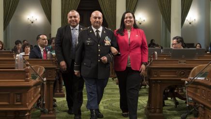 Assemblymember Freddie Rodriguez and Assemblymember Wendy Carillo escort Latino Spirit Award Recipient Hector Barajas