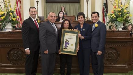 Maria Alonso, Assemblymember Freddie Rodriguez, and Legislative Leaders on the Assembly Floor of the State Capitol